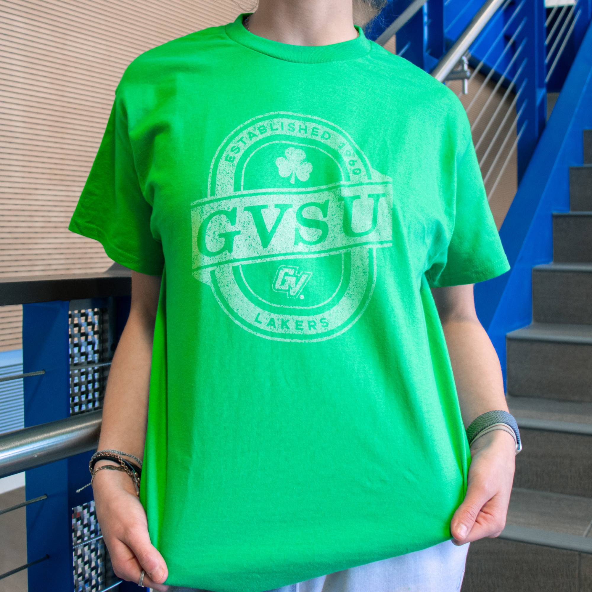 student modeling a green St. Patrick's day t-shirt